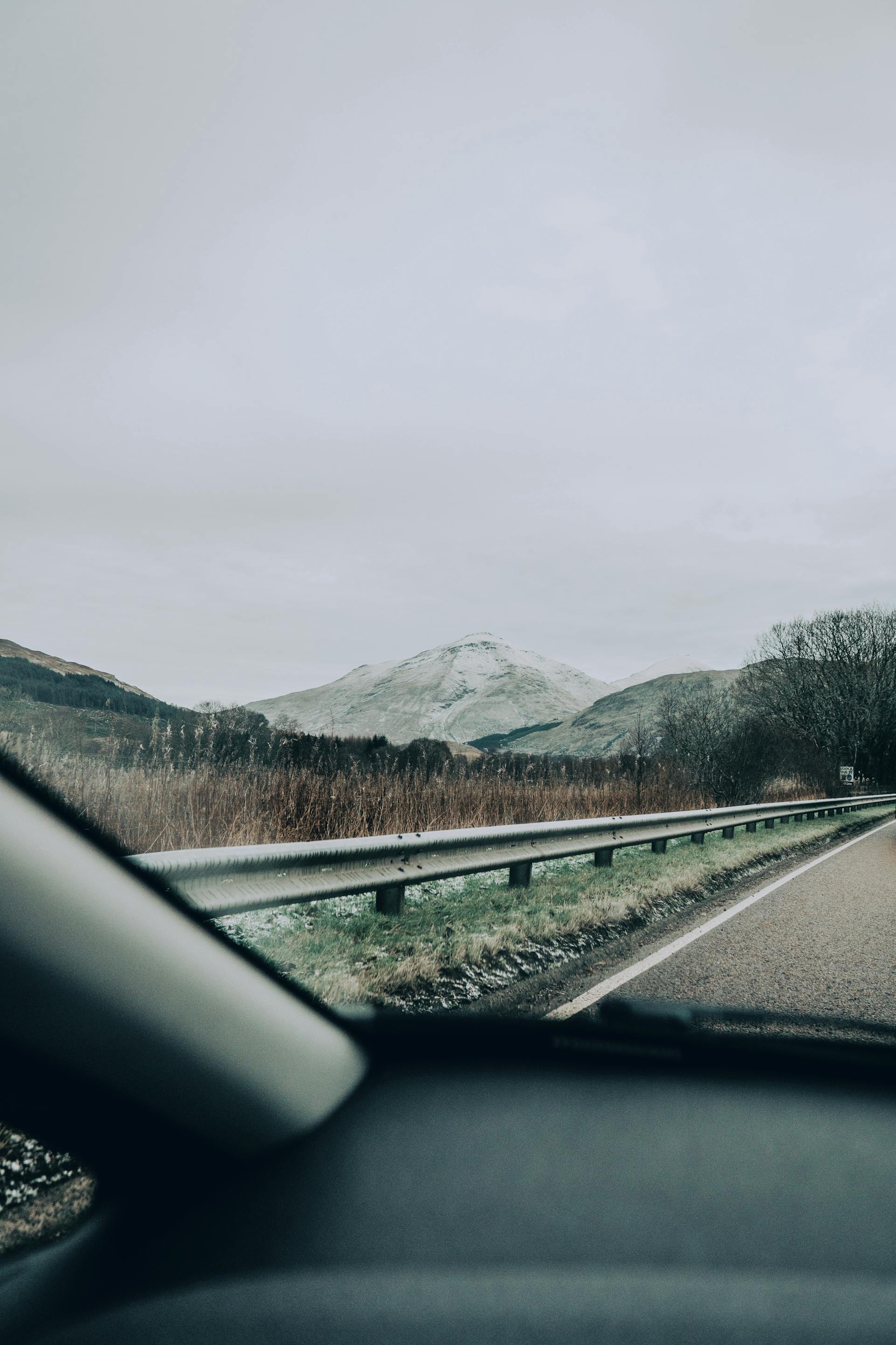 Winding coastal road along the NC500 route in northern Scotland