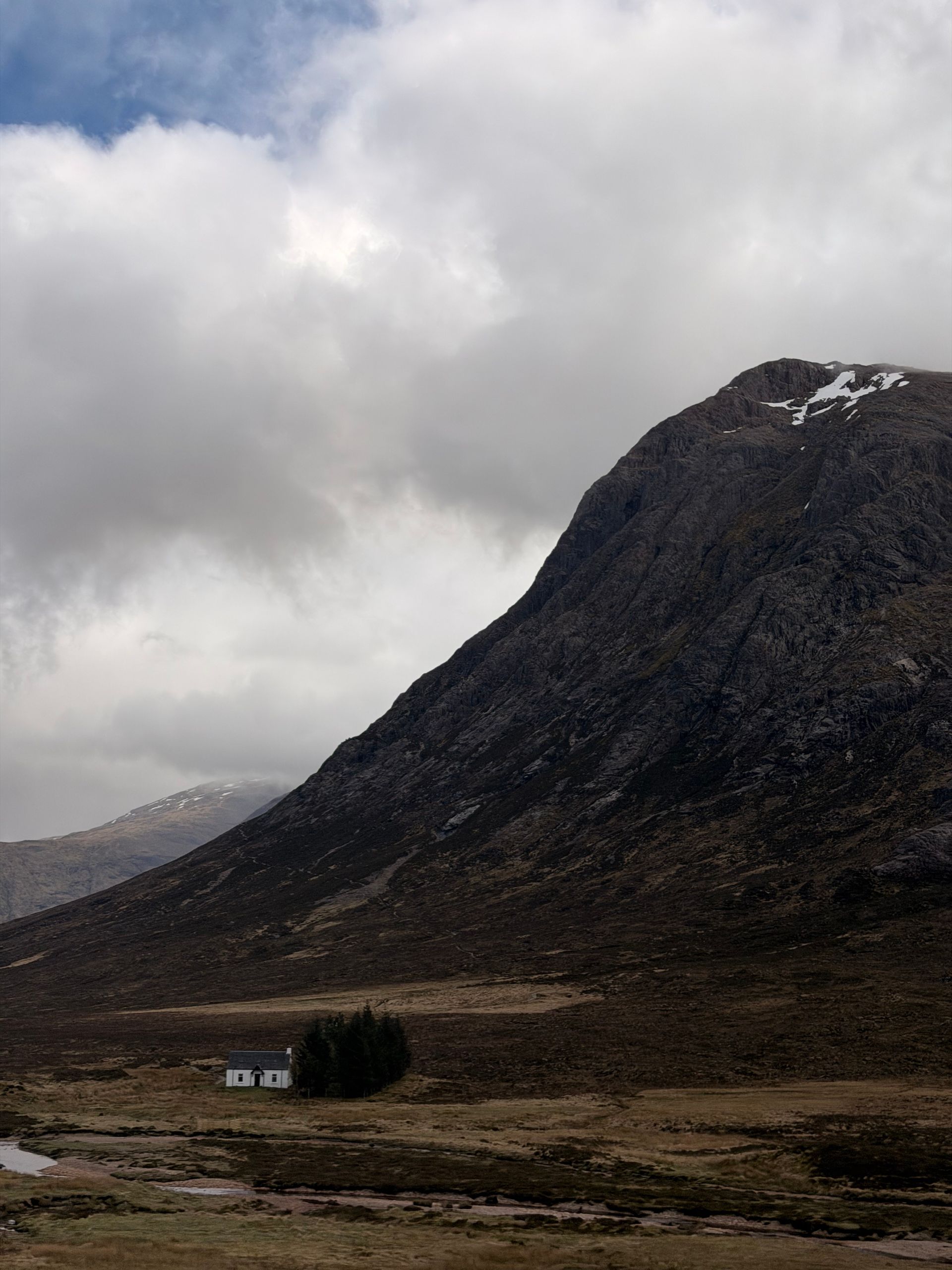 Glencoe valley with dramatic mountain peaks and waterfall