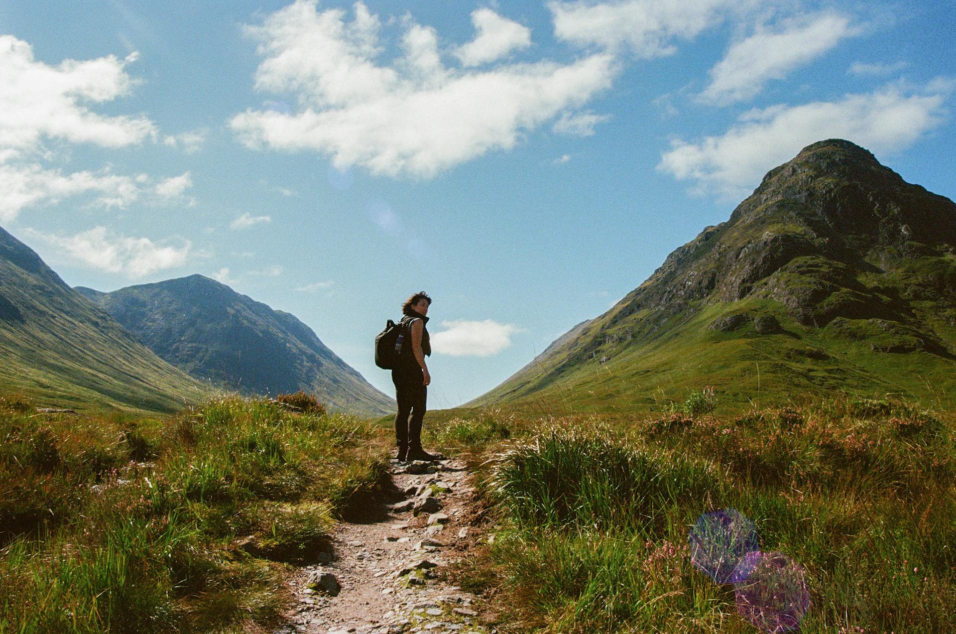 Hiker on a mountain trail in the Scottish Highlands