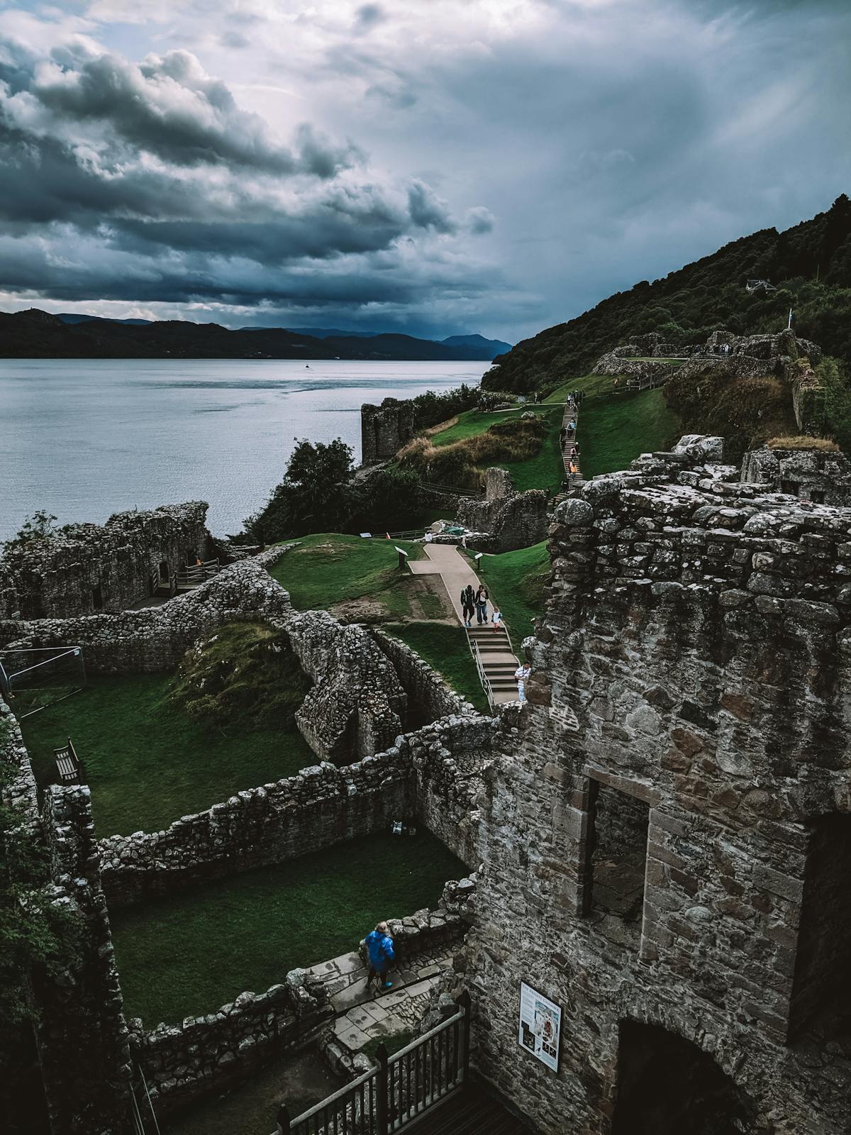 Urquhart Castle ruins on the shore of Loch Ness with the Great Glen stretching behind